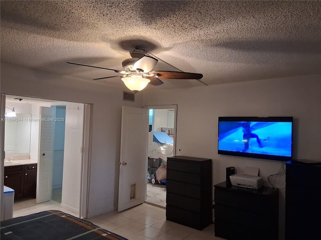 3905 N Nob Hill Rd Unit 510, Sunrise, FL 33351 - bedroom featuring a sink, light tile patterned flooring, ceiling fan, a textured ceiling, and ensuite bath