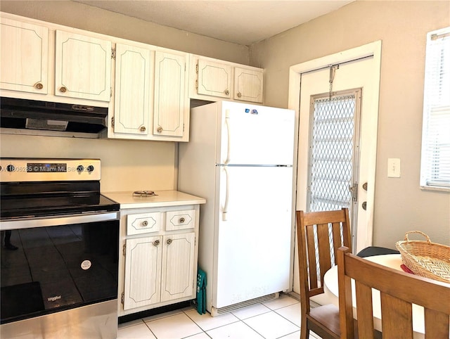 1280 NW 43rd Ave Unit 205, Lauderhill, FL 33313 - kitchen featuring freestanding refrigerator, stainless steel electric range oven, under cabinet range hood, light countertops, and light tile patterned flooring