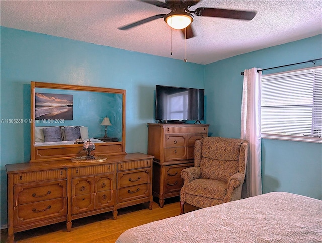 1280 NW 43rd Ave Unit 205, Lauderhill, FL 33313 - bedroom featuring wood finished floors, a textured ceiling, and ceiling fan
