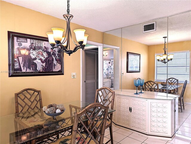 1280 NW 43rd Ave Unit 205, Lauderhill, FL 33313 - dining room featuring a chandelier, light tile patterned flooring, and a textured ceiling