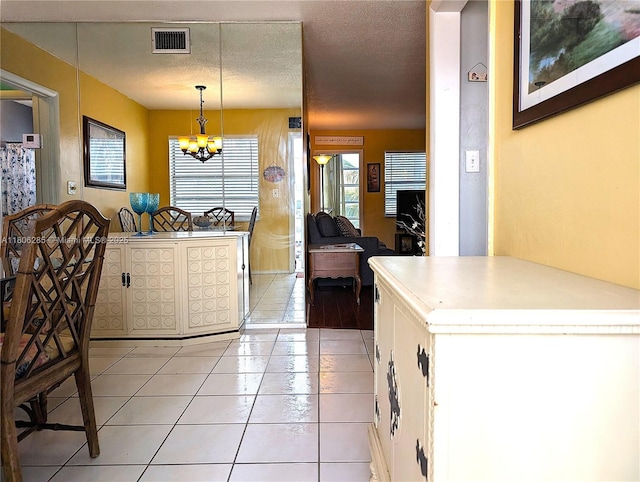1280 NW 43rd Ave Unit 205, Lauderhill, FL 33313 - kitchen featuring a chandelier, light tile patterned flooring, pendant lighting, and light countertops