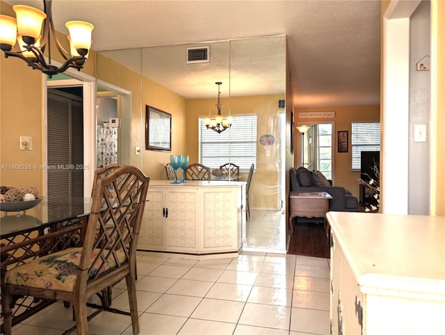 1280 NW 43rd Ave Unit 205, Lauderhill, FL 33313 - dining space with a chandelier and light tile patterned floors