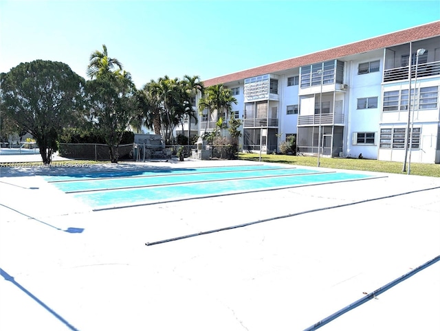 1280 NW 43rd Ave Unit 205, Lauderhill, FL 33313 - view of swimming pool with shuffleboard and fence