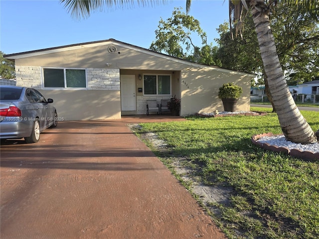 6626 SW 1st Ct, Pembroke Pines, FL 33023 - view of front of house with stone siding, a front lawn, and stucco siding