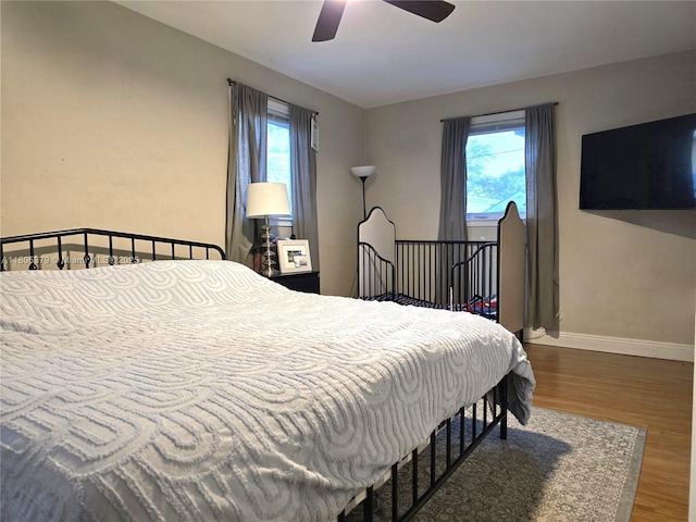6626 SW 1st Ct, Pembroke Pines, FL 33023 - bedroom with wood finished floors, multiple windows, baseboards, and a ceiling fan