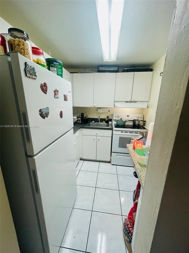 17101 NW 57th Ave Unit 314, Miami Gardens, FL 33055 - kitchen featuring white appliances, a sink, light tile patterned flooring, under cabinet range hood, and white cabinetry