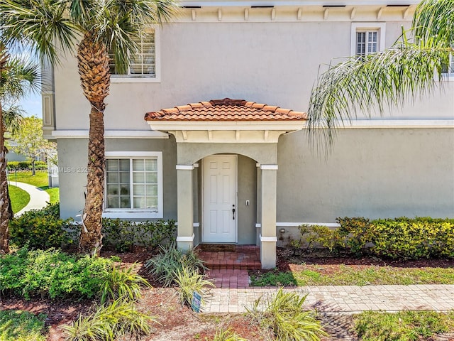 2801 SW 81st Ter, Miramar, FL 33025 - doorway to property featuring stucco siding and a tiled roof