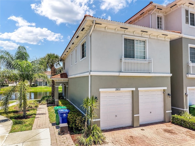2801 SW 81st Ter, Miramar, FL 33025 - view of front of property featuring an attached garage, decorative driveway, stucco siding, a water view, and a tile roof