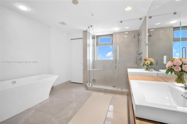 17301 Biscayne Blvd Unit 1108, Aventura, FL 33160 - bathroom featuring a stall shower, plenty of natural light, vanity, a soaking tub, and recessed lighting
