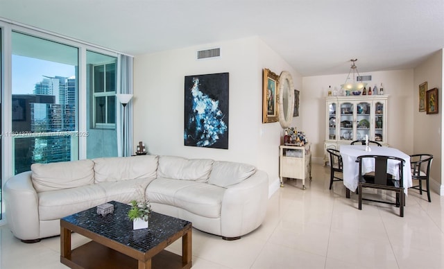 1250 S Miami Ave Unit 3106, Miami, FL 33130 - living room with floor to ceiling windows, baseboards, and light tile patterned flooring