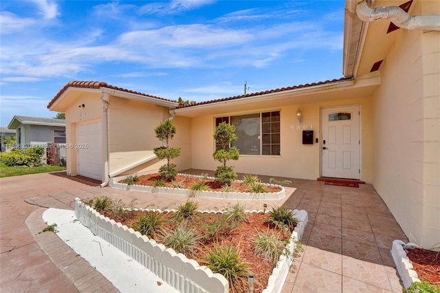 5861 NW 18th Ct, Sunrise, FL 33313 - property entrance featuring stucco siding, a garage, concrete driveway, and a tile roof