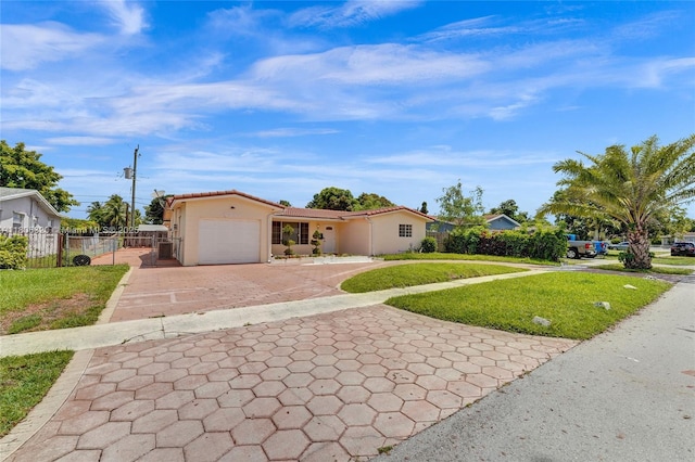 5861 NW 18th Ct, Sunrise, FL 33313 - view of front of home featuring decorative driveway, a garage, stucco siding, and a tiled roof