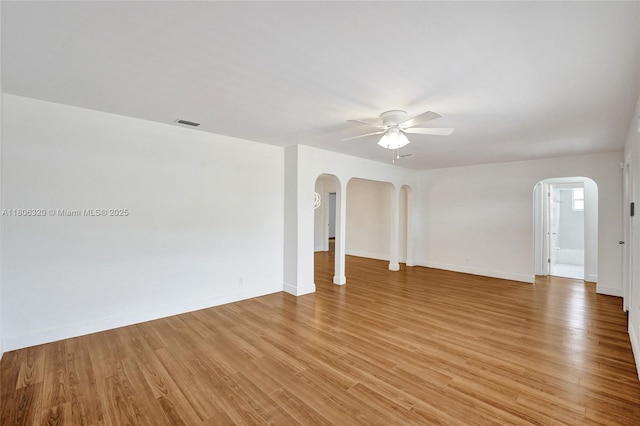 5861 NW 18th Ct, Sunrise, FL 33313 - unfurnished room with ceiling fan, arched walkways, light wood-type flooring, and baseboards