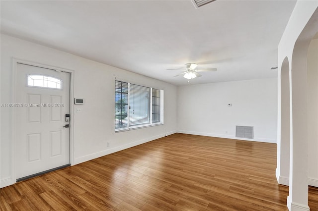 5861 NW 18th Ct, Sunrise, FL 33313 - foyer entrance with arched walkways, a ceiling fan, wood finished floors, and baseboards