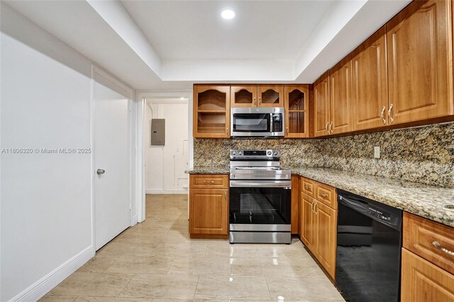 5861 NW 18th Ct, Sunrise, FL 33313 - kitchen featuring appliances with stainless steel finishes, backsplash, a raised ceiling, light stone countertops, and electric panel