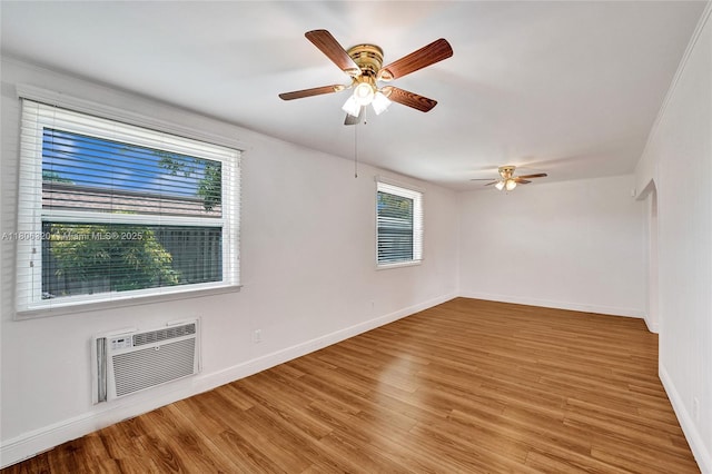 5861 NW 18th Ct, Sunrise, FL 33313 - empty room featuring light wood finished floors, a wall unit AC, a ceiling fan, and baseboards