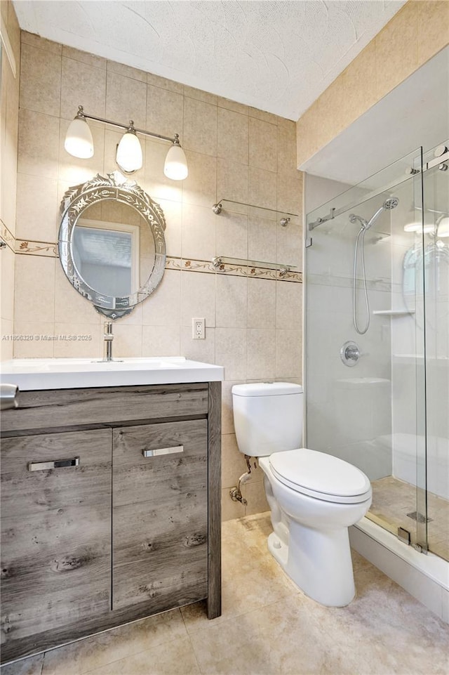 5861 NW 18th Ct, Sunrise, FL 33313 - bathroom with tile walls, a stall shower, vanity, toilet, and tile patterned floors