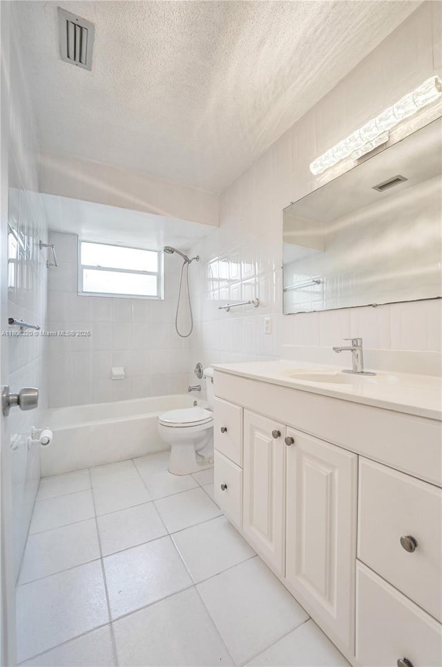 5861 NW 18th Ct, Sunrise, FL 33313 - bathroom featuring tub / shower combination, toilet, vanity, tile patterned flooring, and a textured ceiling