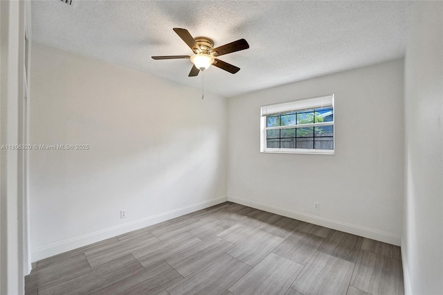 5861 NW 18th Ct, Sunrise, FL 33313 - unfurnished room featuring a textured ceiling, ceiling fan, wood finished floors, and baseboards