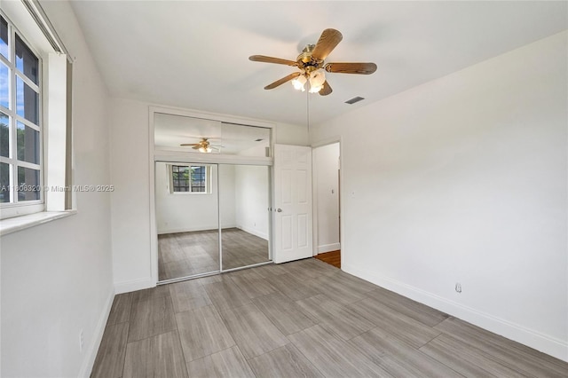 5861 NW 18th Ct, Sunrise, FL 33313 - unfurnished bedroom featuring baseboards, a closet, and wood finished floors