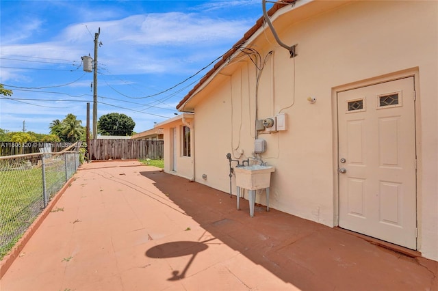 5861 NW 18th Ct, Sunrise, FL 33313 - view of side of property with stucco siding and a patio