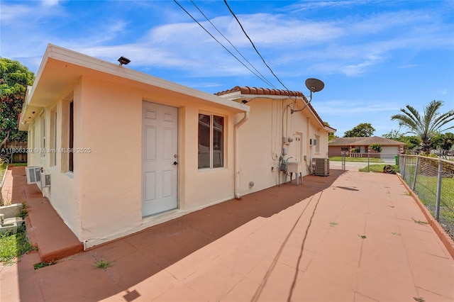 5861 NW 18th Ct, Sunrise, FL 33313 - view of property exterior with stucco siding, a patio, a tiled roof, and central AC