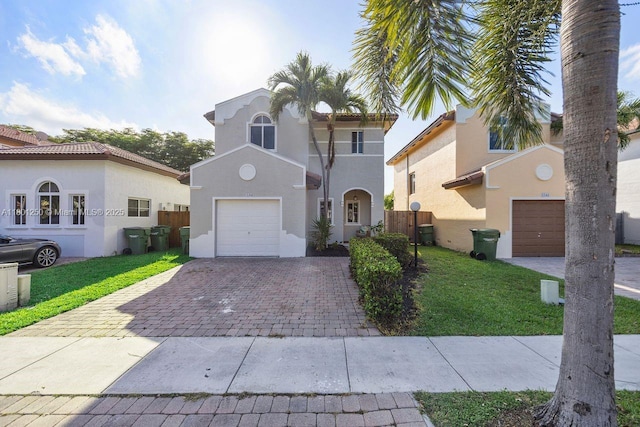1136 NE 41st Ave, Homestead, FL 33033 - mediterranean / spanish-style home featuring decorative driveway, stucco siding, and an attached garage