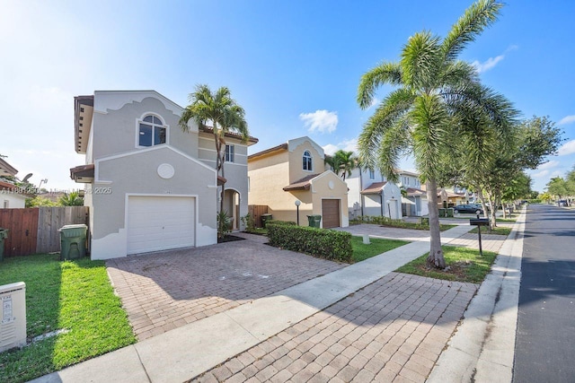1136 NE 41st Ave, Homestead, FL 33033 - view of front of property featuring decorative driveway, a garage, stucco siding, and a residential view