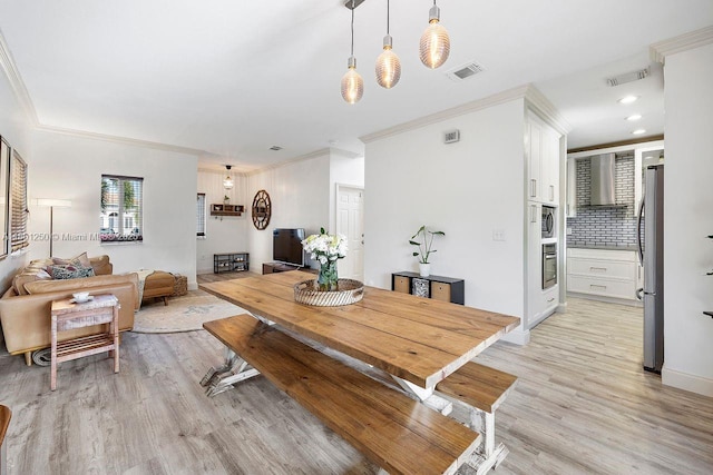 1136 NE 41st Ave, Homestead, FL 33033 - dining space with light wood-style flooring, ornamental molding, recessed lighting, and baseboards