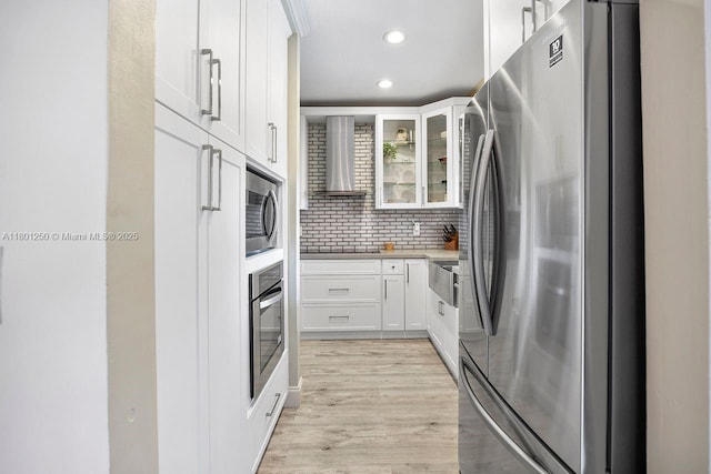 1136 NE 41st Ave, Homestead, FL 33033 - kitchen with appliances with stainless steel finishes, wall chimney exhaust hood, white cabinetry, recessed lighting, and glass insert cabinets