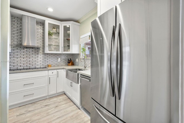 1136 NE 41st Ave, Homestead, FL 33033 - kitchen featuring appliances with stainless steel finishes, wall chimney exhaust hood, white cabinetry, glass insert cabinets, and tasteful backsplash