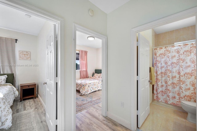 1136 NE 41st Ave, Homestead, FL 33033 - bedroom with baseboards and light wood finished floors