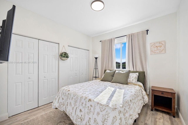 1136 NE 41st Ave, Homestead, FL 33033 - bedroom featuring two closets, light wood finished floors, and baseboards