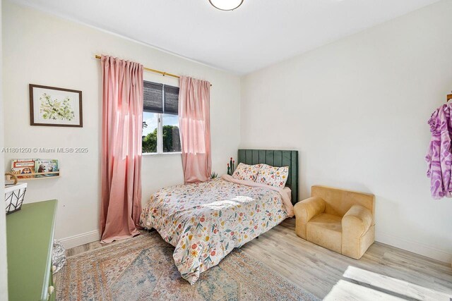 1136 NE 41st Ave, Homestead, FL 33033 - bedroom with baseboards and wood finished floors