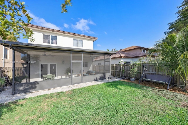 1136 NE 41st Ave, Homestead, FL 33033 - rear view of house with a sunroom, ceiling fan, stucco siding, and a tiled roof