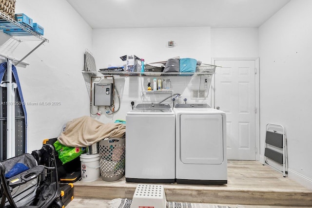 1136 NE 41st Ave, Homestead, FL 33033 - laundry area with washer and clothes dryer, heating unit, light wood finished floors, and baseboards