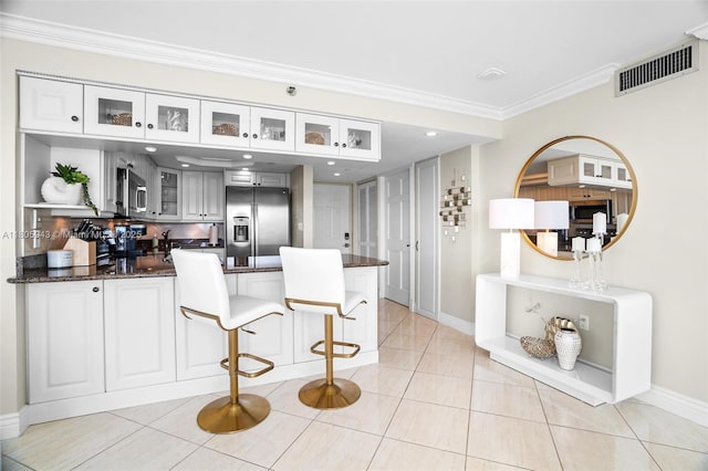 18000 N Bay Rd Unit 803, Sunny Isles Beach, FL 33160 - kitchen featuring stainless steel appliances, a peninsula, baseboards, ornamental molding, and open shelves