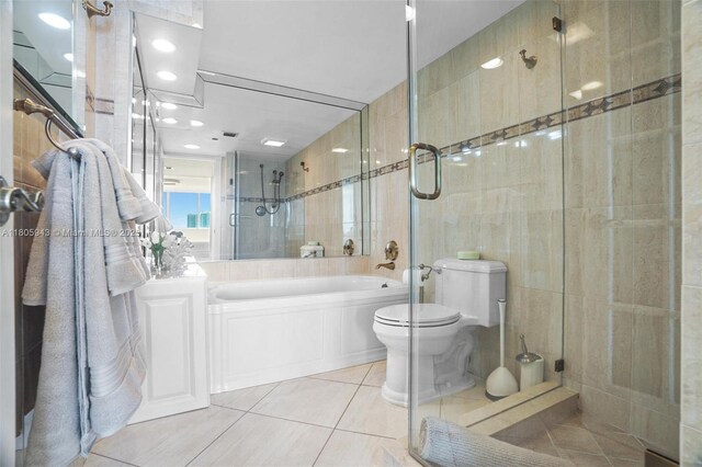 18000 N Bay Rd Unit 803, Sunny Isles Beach, FL 33160 - bathroom with toilet, tile patterned flooring, a tile shower, a bath, and tile walls