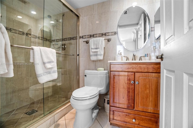 18000 N Bay Rd Unit 803, Sunny Isles Beach, FL 33160 - bathroom with vanity, toilet, tile patterned flooring, a stall shower, and tile walls