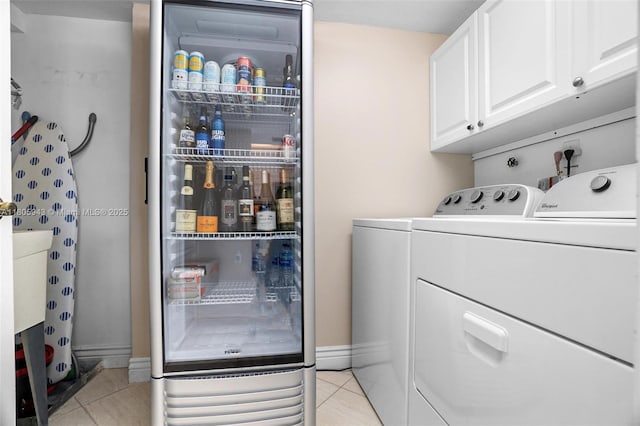 18000 N Bay Rd Unit 803, Sunny Isles Beach, FL 33160 - laundry area featuring cabinet space, light tile patterned flooring, washer and clothes dryer, and baseboards