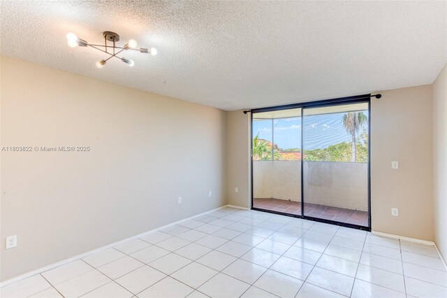7401 NW 16th St Unit 408, Plantation, FL 33313 - unfurnished room with a textured ceiling, light tile patterned floors, baseboards, and a chandelier