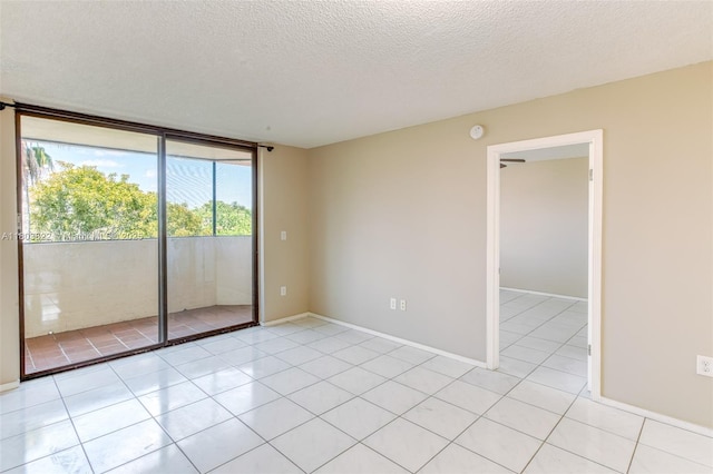 7401 NW 16th St Unit 408, Plantation, FL 33313 - empty room with a textured ceiling, light tile patterned floors, baseboards, and a smoke detector
