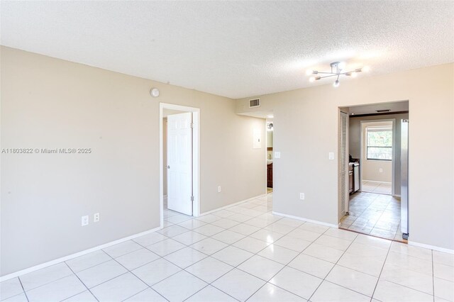 7401 NW 16th St Unit 408, Plantation, FL 33313 - empty room featuring a textured ceiling, baseboards, and light tile patterned floors