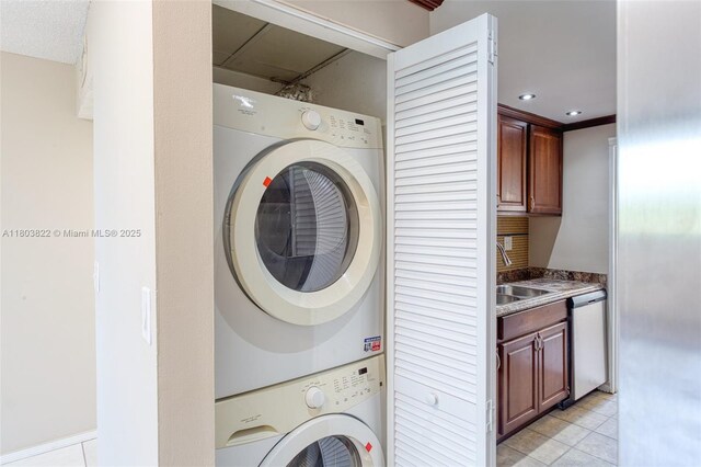 7401 NW 16th St Unit 408, Plantation, FL 33313 - washroom with stacked washer / drying machine, light tile patterned floors, and recessed lighting
