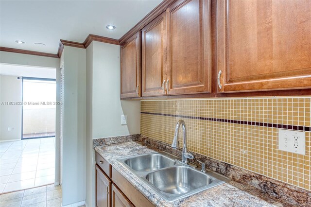 7401 NW 16th St Unit 408, Plantation, FL 33313 - kitchen with a sink, ornamental molding, light tile patterned floors, tasteful backsplash, and baseboards