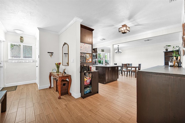 9491 SW 54th St, Miami, FL 33165 - hall with crown molding, a chandelier, light wood-style flooring, and baseboards