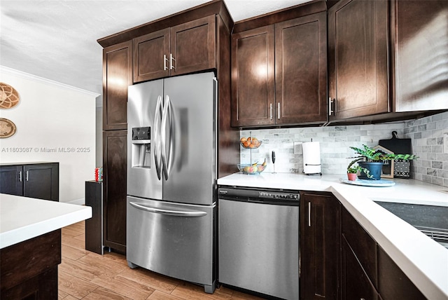 9491 SW 54th St, Miami, FL 33165 - kitchen with stainless steel appliances, decorative backsplash, light countertops, dark brown cabinetry, and crown molding