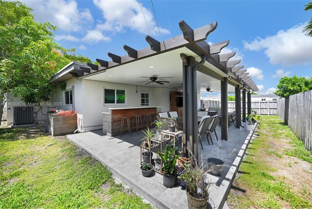 9491 SW 54th St, Miami, FL 33165 - fenced backyard with central AC, a ceiling fan, and a patio