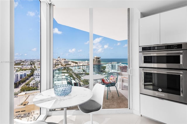 300 S Pointe Dr Unit 2005, Miami Beach, FL 33139 - kitchen with double oven, a water view, white cabinets, and a view of city