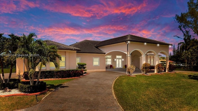 4800 SW 141st Ave, Miramar, FL 33027 - mediterranean / spanish house with asphalt driveway, stucco siding, and a lawn